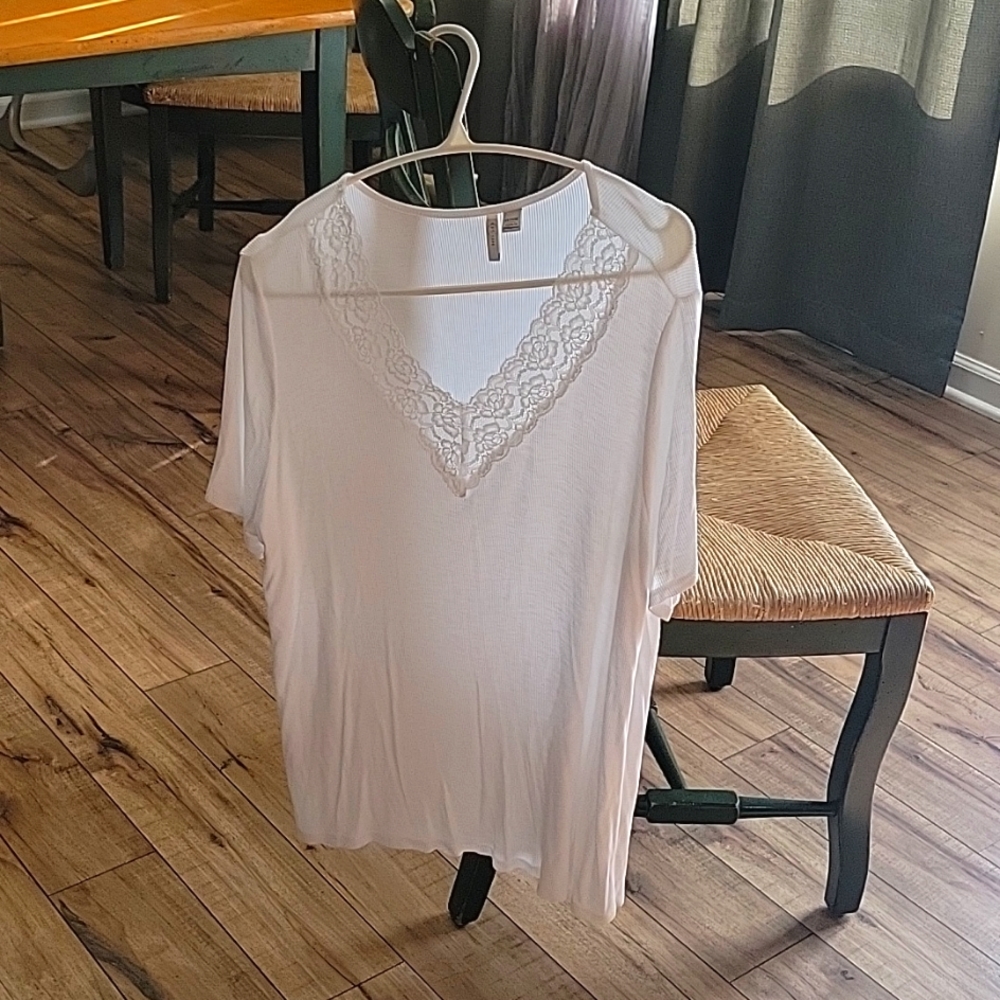 Womens thin white tee with a lace type neck line.